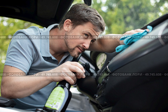 man vacuum cleaning his car interior. Стоковое фото, агентство Ingram Publishing / Фотобанк Лори