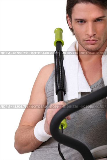 Man with a chest expander. Стоковое фото, агентство Ingram Publishing / Фотобанк Лори