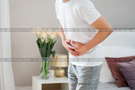 Man with abdominal pain suffering at home. Стоковое фото, фотограф Станислав Тарко / Фотобанк Лори