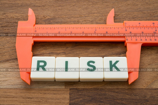 Measuring word RISK with vernier caliper tool on wooden table background. Planning, risk management or evalution and business finance strategy concept.. Measuring,Word,Risk,With,Vernier,Caliper,Tool,On,Wooden,Table. Стоковое фото, агентство Ingram Publishing / Фотобанк Лори