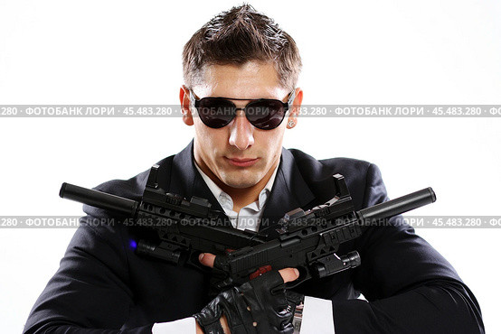 Men in black suit holding gun. Стоковое фото, фотограф Андрей Аркуша / Фотобанк Лори