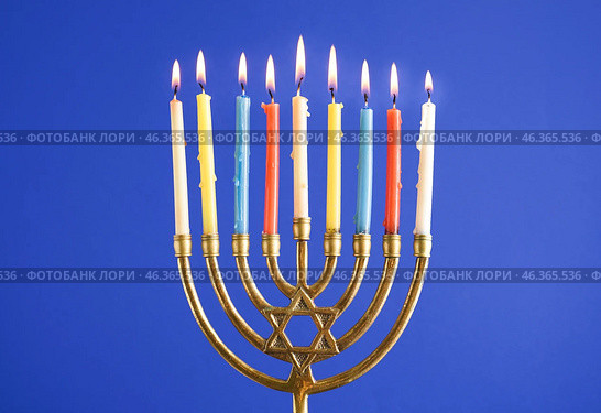 Menorah with burning candles for Hannukah celebration on blue background, closeup. Стоковое фото, фотограф Pixel_shot / Фотобанк Лори