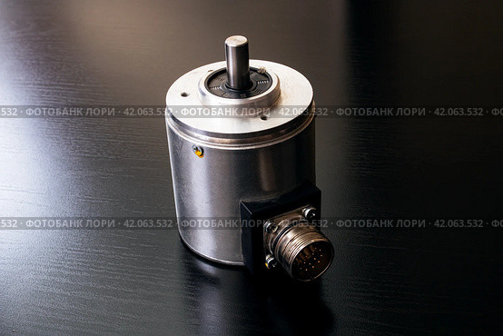 Metal encoder on a black wooden table. Стоковое фото, фотограф Аксенова Вера / Фотобанк Лори