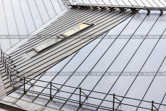 Metal roof with railings and attic window, modern architecture. Стоковое фото, фотограф EugeneSergeev / Фотобанк Лори