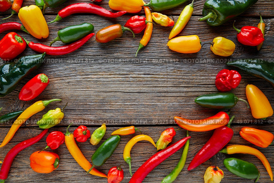 Mexican hot chili peppers colorful mix habanero poblano serrano jalapeno on wood. Стоковое фото, агентство Ingram Publishing / Фотобанк Лори