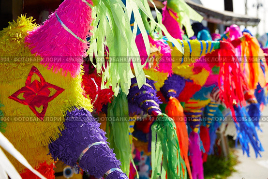 Mexican party pinatas decorated with fringed tissue colorful paper. Стоковое фото, агентство Ingram Publishing / Фотобанк Лори