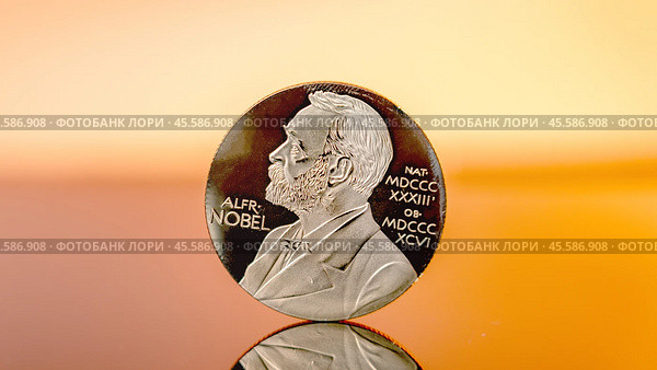 Moscow December 03 2024. Close-up of Alfred Nobel's engraving on coin. Nobel Peace Prize concept. Nobel Prize award. Редакционное фото, фотограф Скрипачев Антон / Фотобанк Лори