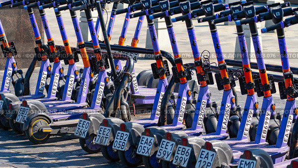 Moscow July 25 2025, row of electric scooters are lined up on the pavement. Редакционное фото, фотограф Скрипачев Антон / Фотобанк Лори