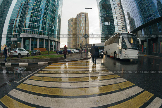 Moscow, Russia - September 18, 2019: Workout time. Working day had been finished, people leave office. MIBC Moscow International Business Center. Rain autumn business concepts. Fish-Eye technique lens. Редакционное фото, фотограф YuryKara / Фотобанк Лори