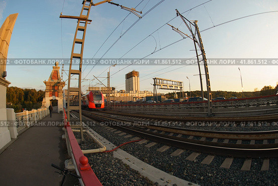Moscow, Russia - September 26, 2019: Photography of train of Moscow Central Circle / MCC. Fashionable and comfortable Lastochka commuter train in the motion. Academy of Sciences in distance. Fish eye. Редакционное фото, фотограф YuryKara / Фотобанк Лори
