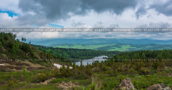 Mountain lake time-lapse at the summer or autumn time. Wild nature and rural field. Clouds movement, green grass and dramatic sky. Motorised dolly slider. Стоковое видео, видеограф Александр Маркин / Фотобанк Лори