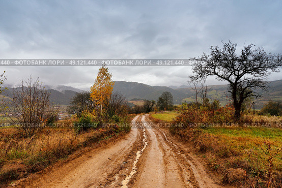 Muddy ground after rain in Carpathian mountains. Extreme path rural dirt road in the hills. Bad weather. Стоковое фото, агентство Ingram Publishing / Фотобанк Лори