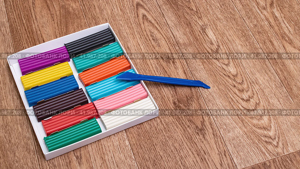 Multicolored plasticine in box closeup on wooden background. Стоковое фото, фотограф Аксенова Вера / Фотобанк Лори