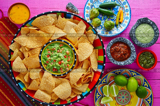 Nachos with guacamole tortilla chips in sombrero plate and sauces. Стоковое фото, агентство Ingram Publishing / Фотобанк Лори