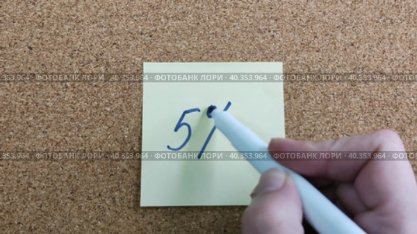 Надпись 5% на бумажном стикере приклеенном к пробковой  доске. Женщина пишет маркером на желтой бумаге. Синий фломастер в женской руке. Рукописный текст красивым почерком. Процент скидки или прибыли. The inscription is 5% on a paper sticker glued to a cork board. A woman writes with a marker on yellow paper. A blue felt-tip pen in a woman's hand. Handwritten text in a beautiful handwriting. Percentage of discount or profit. Стоковое видео, видеограф Ирина / Фотобанк Лори