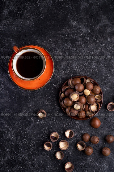 natural  macadamia nuts and black coffee served at black table.food  and wellness concept . Стоковое фото, агентство Ingram Publishing / Фотобанк Лори
