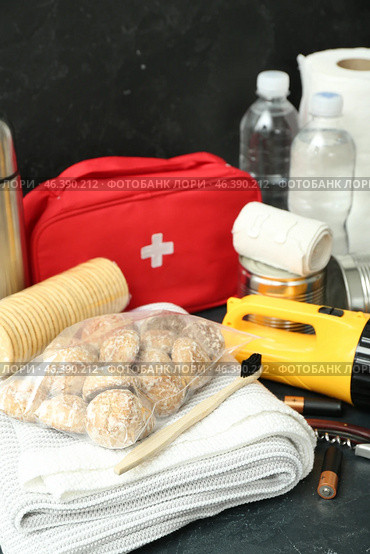 Necessities for emergency bag on dark table, closeup. Стоковое фото, фотограф Pixel_shot / Фотобанк Лори