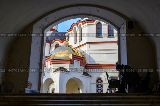 NEW ATHOS, ABKHAZIA - 27 JANUARY, 2022: A monk paints pictures at the entrance to the New Athos Simone-Kananite Monastery in Abkhazia, founded in 1875 and consecrated in 1900. Редакционное фото, фотограф Сергей Фролов / Фотобанк Лори
