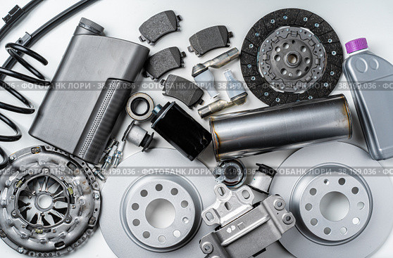 New metal auto parts on grey background. Стоковое фото, фотограф Сергей Толмачёв / Фотобанк Лори