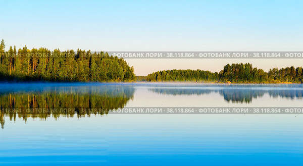 Nice panoramic view of Lake Haukivesi during sunrise. Light fog over the water. Specular reflection in the water. Стоковое фото, фотограф Михаил Аккуратoв / Фотобанк Лори