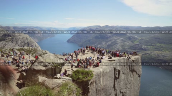 NORWAY- June 15, 2019: Preikestolen or Prekestolen, also known by the English translations of Preacher's Pulpit or Pulpit Rock, is a famous tourist attraction in Forsand, Ryfylke, Norway (2020 год). Стоковое видео, видеограф Андрей Армягов / Фотобанк Лори