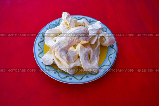 Oaxaca cheese from Mexico in a plate on red background. Стоковое фото, агентство Ingram Publishing / Фотобанк Лори
