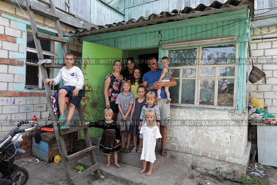 Общая фотография многодетной семьи на крыльце своего дома (2024 год). Редакционное фото, фотограф Дмитрий Неумоин / Фотобанк Лори