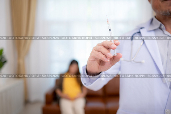 Obstetrician gynecologist and vaccination needle or pregnant woman, Asian pregnant woman visit gynecologist doctor at medical clinic for pregnancy consultant. Стоковое фото, агентство Ingram Publishing / Фотобанк Лори