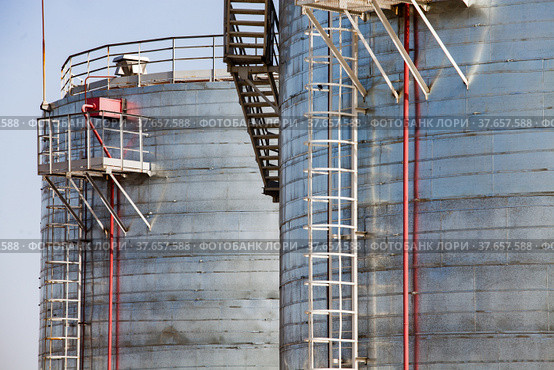 Oil refinery and gas processing plant warehouse. Close-up of galvanizing steel storage tanks on grey sky background. Taraz city, Kazakstan. Стоковое фото, фотограф Alexey Rezvykh / Фотобанк Лори