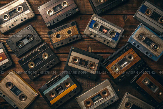 Old audio cassettes with retro music. View from above. Music media from previous years. Стоковое AI-изображение, AI-художник Photojuli / Фотобанк Лори