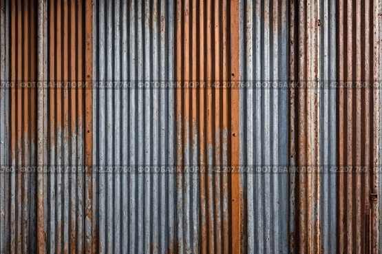 Old industrial corrugated iron industrial texture wall made of tin sheets. Grunge metal plate background. Copy ad text space. Стоковое AI-изображение, AI-художник Aleksandr Golubev / Фотобанк Лори