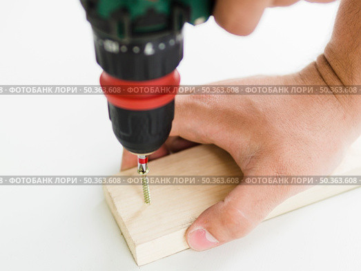 OLYMPUS DIGITAL CAMERA. using perforator with nozzle wooden bar. Стоковое фото, агентство Ingram Publishing / Фотобанк Лори