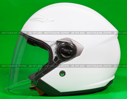 Open face white motorcycle helmet with attached face shield, side view, green background. Стоковое фото, фотограф Кекяляйнен Андрей / Фотобанк Лори