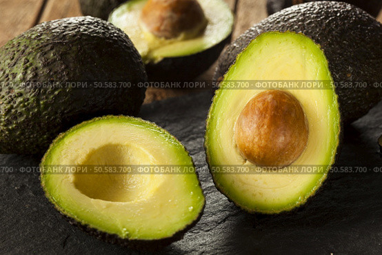 Organic Raw Green Avocados Sliced in Half. Стоковое фото, агентство Ingram Publishing / Фотобанк Лори