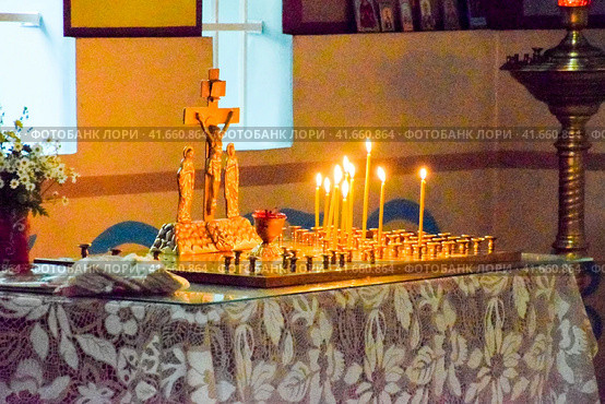 Orthodox church from the inside. Burning wax candles in front of icons and frescoes. Christian religion. Стоковое фото, фотограф Леонид Еремейчук / Фотобанк Лори