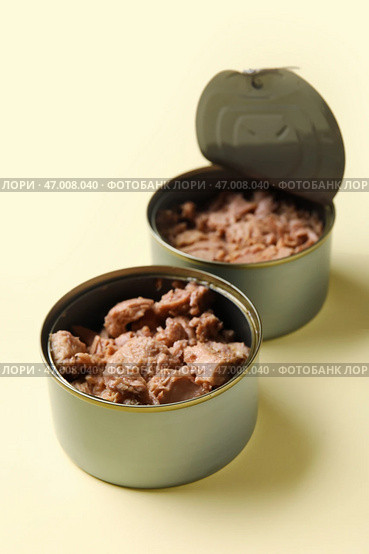 Открытые консервные банки со вкусным тунцом на бежевом фоне. Стоковое фото, фотограф Pixel_shot / Фотобанк Лори