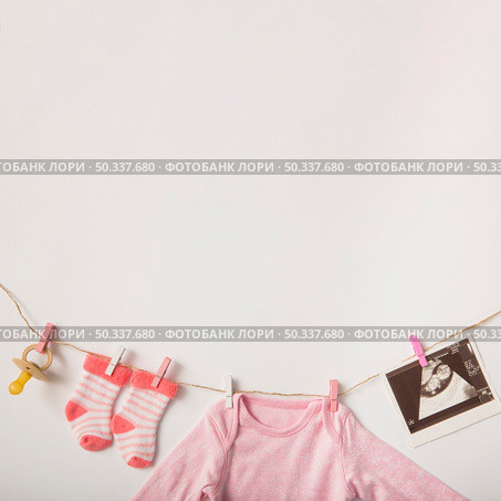 pacifier sonography picture socks baby clothing hanging clothesline white background. Стоковое фото, агентство Ingram Publishing / Фотобанк Лори