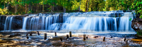 Panorama of Tropical waterfall Phnom Kulen, Cambodia. Tropical waterfall in jungle with motion blur. Стоковое фото, агентство Ingram Publishing / Фотобанк Лори