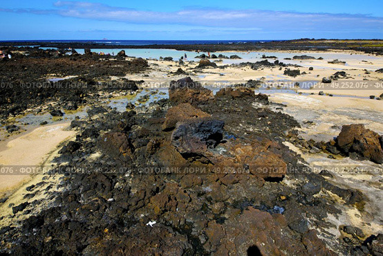 people footstep coaststone  volcanic spain  water in lanzarote  sky cloud beach  and summer . Стоковое фото, агентство Ingram Publishing / Фотобанк Лори