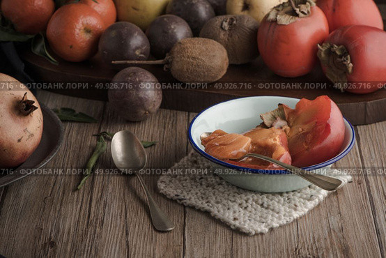 Persimmon fruit on rustic table in vintage style. Стоковое фото, агентство Ingram Publishing / Фотобанк Лори
