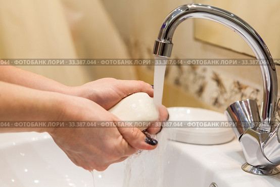 Person soaps hands under a water stream, close up view at Caucasian female arms. Стоковое фото, фотограф Кекяляйнен Андрей / Фотобанк Лори