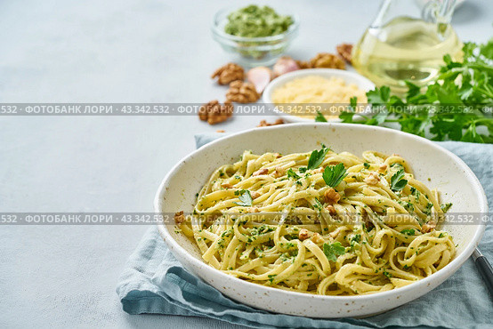 Pesto pasta bavette with walnuts, parsley, garlic, nuts, olive oil. Side view. Стоковое фото, фотограф Natalia Gdovskaia / Фотобанк Лори