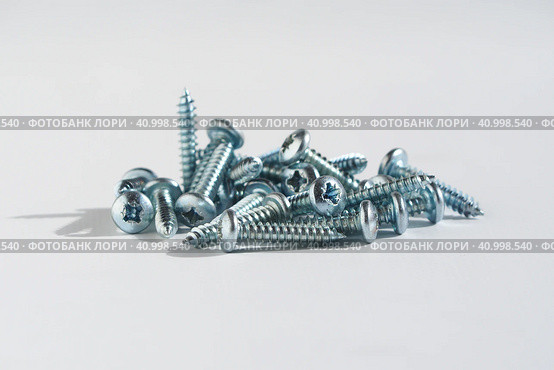 PH type chrome screws on a white background. self tapping screws. Стоковое фото, фотограф Александр Кротков / Фотобанк Лори