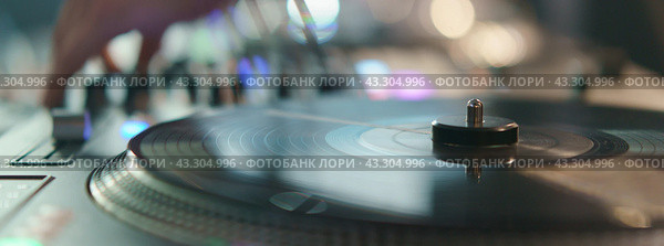 Photography of the modern premium stage mixed board, desk with vinyl turntable and vinyl plate. Close frontal view. Стоковое фото, фотограф YuryKara / Фотобанк Лори