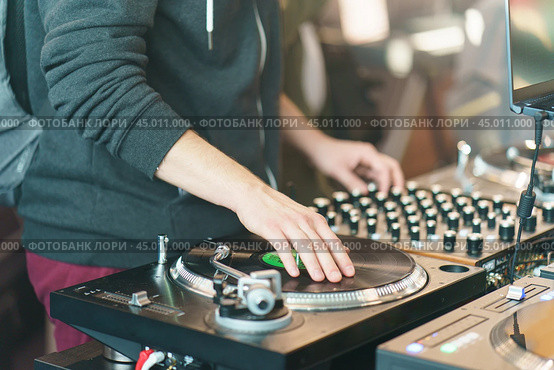Photography of the modern premium stage mixed board / desk with vinyl turntable and vinyl plate. Close frontal view. Стоковое фото, фотограф YuryKara / Фотобанк Лори