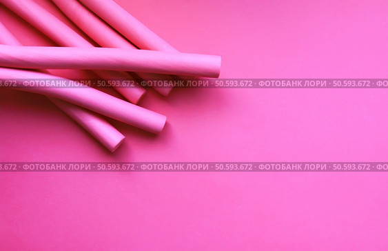 Pink foam curlers on soft pastel background. Hair accessories.. Pink foam curlers on soft pastel background. Hair accessories. Стоковое фото, агентство Ingram Publishing / Фотобанк Лори