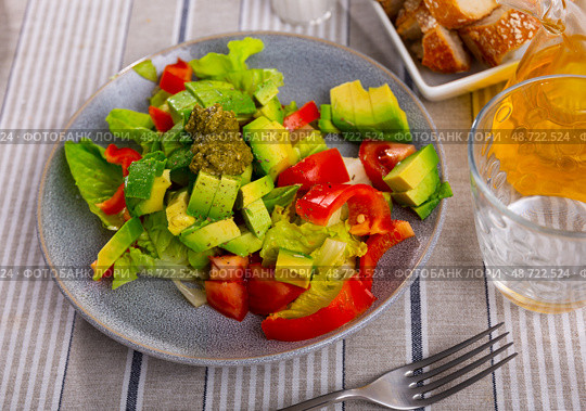 Plate contains portion of salad from fresh vegetables and pesto sauce. Стоковое фото, фотограф Яков Филимонов / Фотобанк Лори