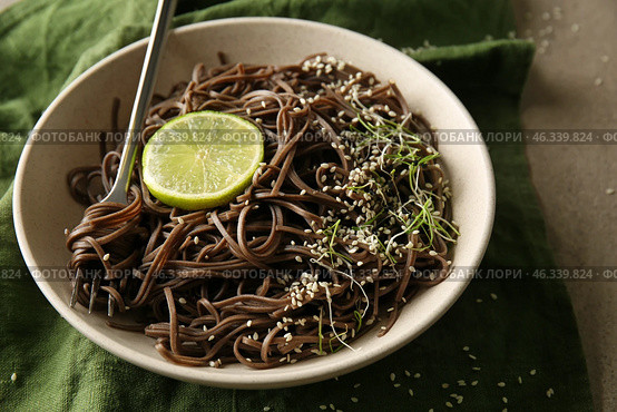 Plate with tasty soba noodles on grey table. Стоковое фото, фотограф Pixel_shot / Фотобанк Лори