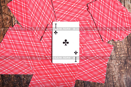 Playing cards scattered on table. Background of scattered deck cards filling inverted reverse side with cross ACE to top entire on textured wooden. Top view, close-up. Copyright space for site. Стоковое фото, фотограф Aleksandr Golubev / Фотобанк Лори