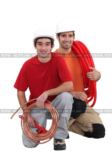 Plumbers with traditional copper pipe. Стоковое фото, агентство Ingram Publishing / Фотобанк Лори